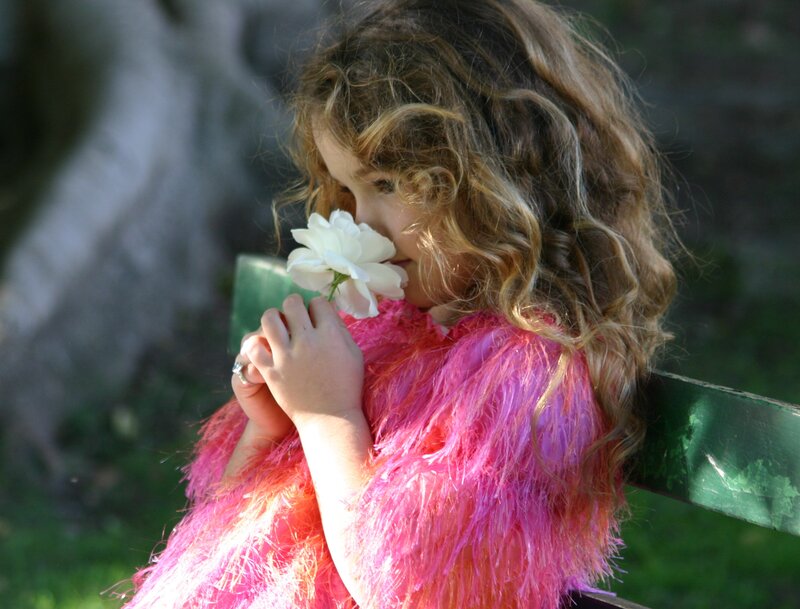 Child Holding White Flower — Pink