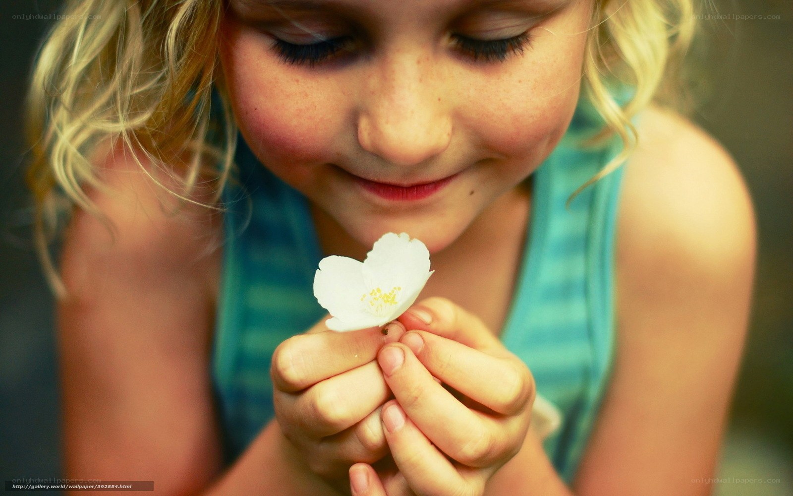 child holding white flower