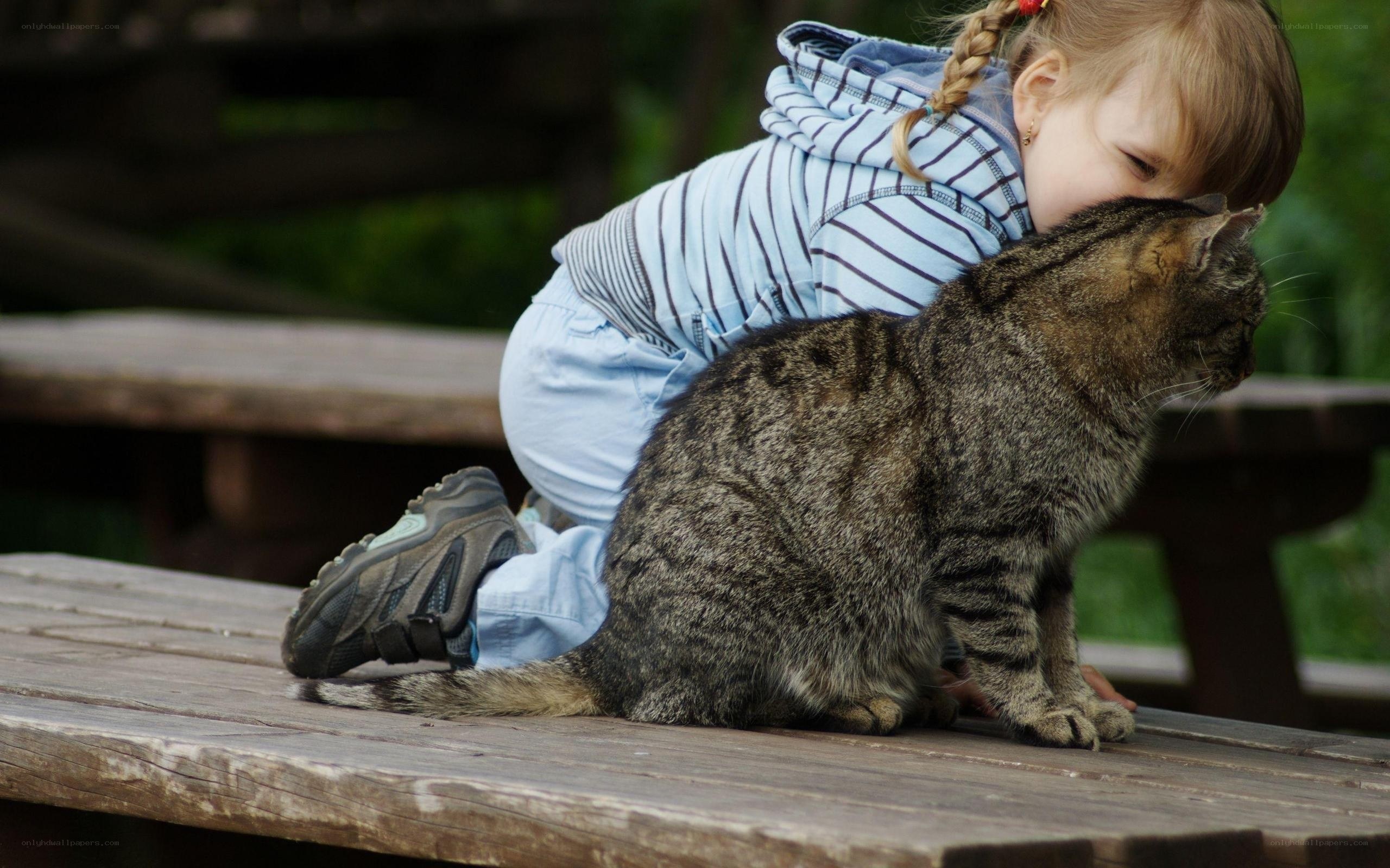 child hugging a cat