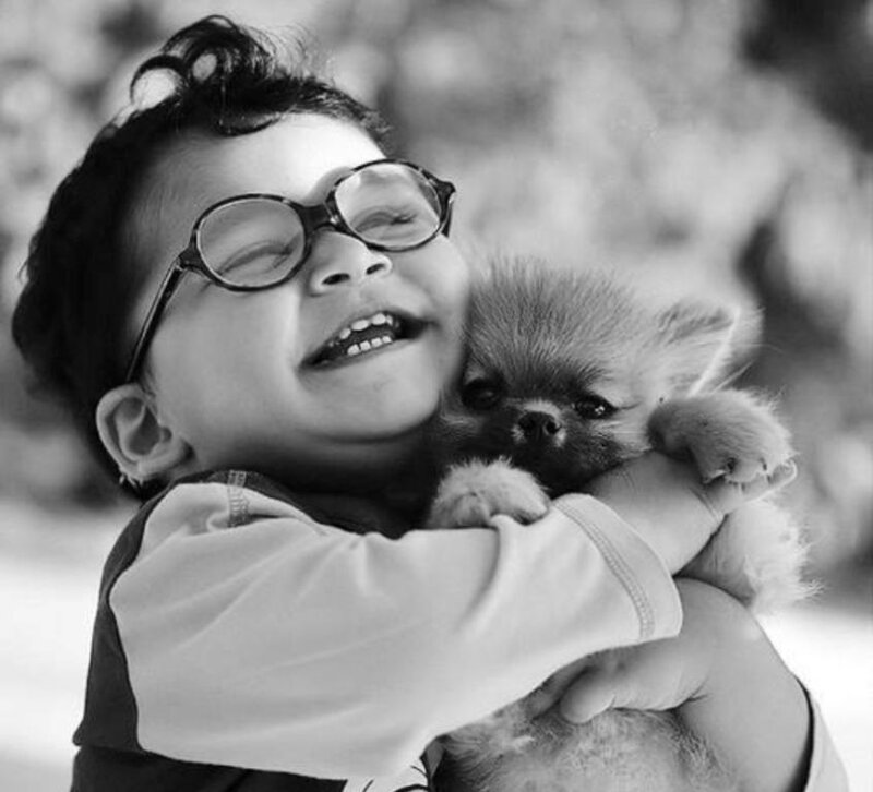 Child Hugging Puppy