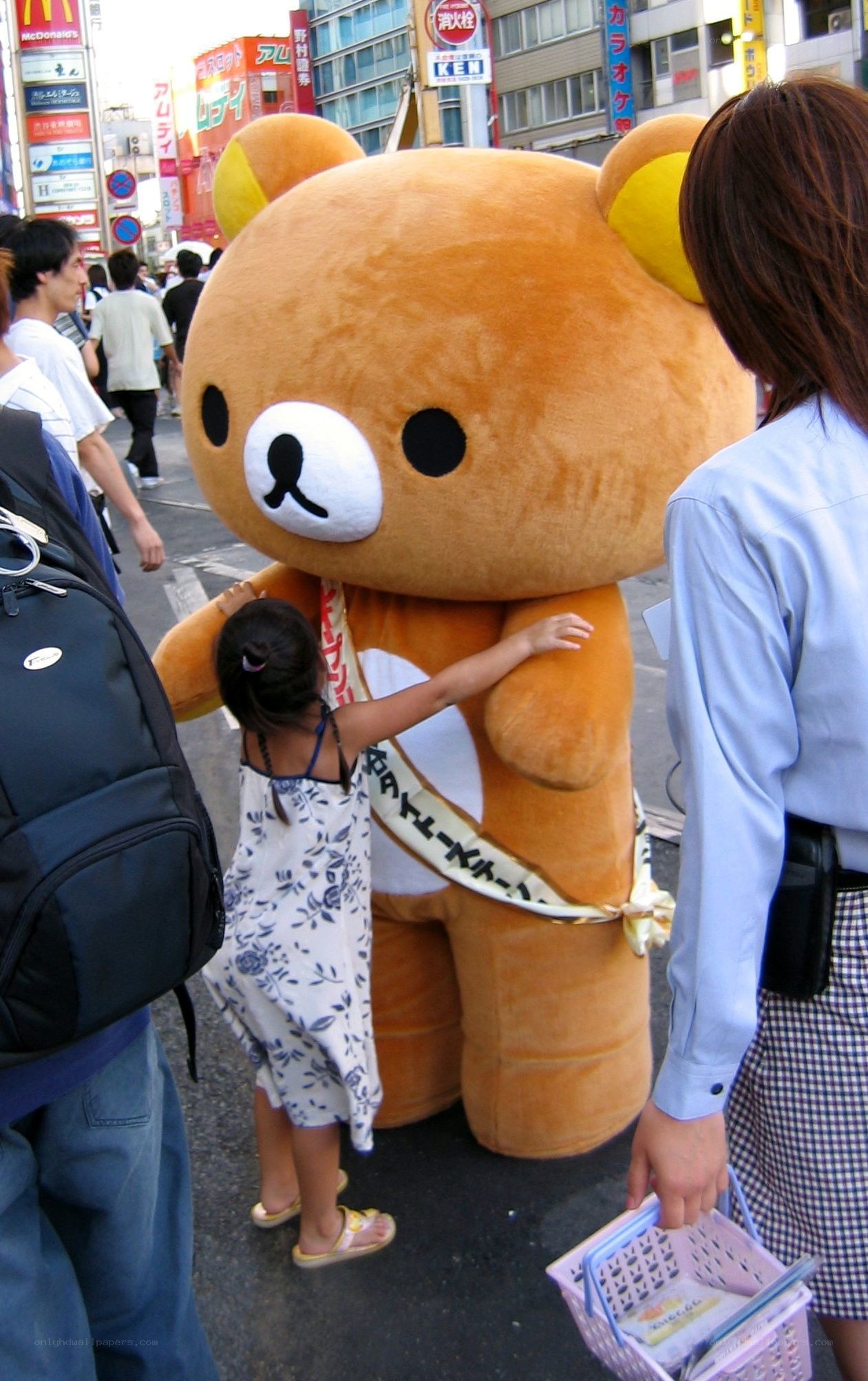 Child hugging Rilakkuma mascot