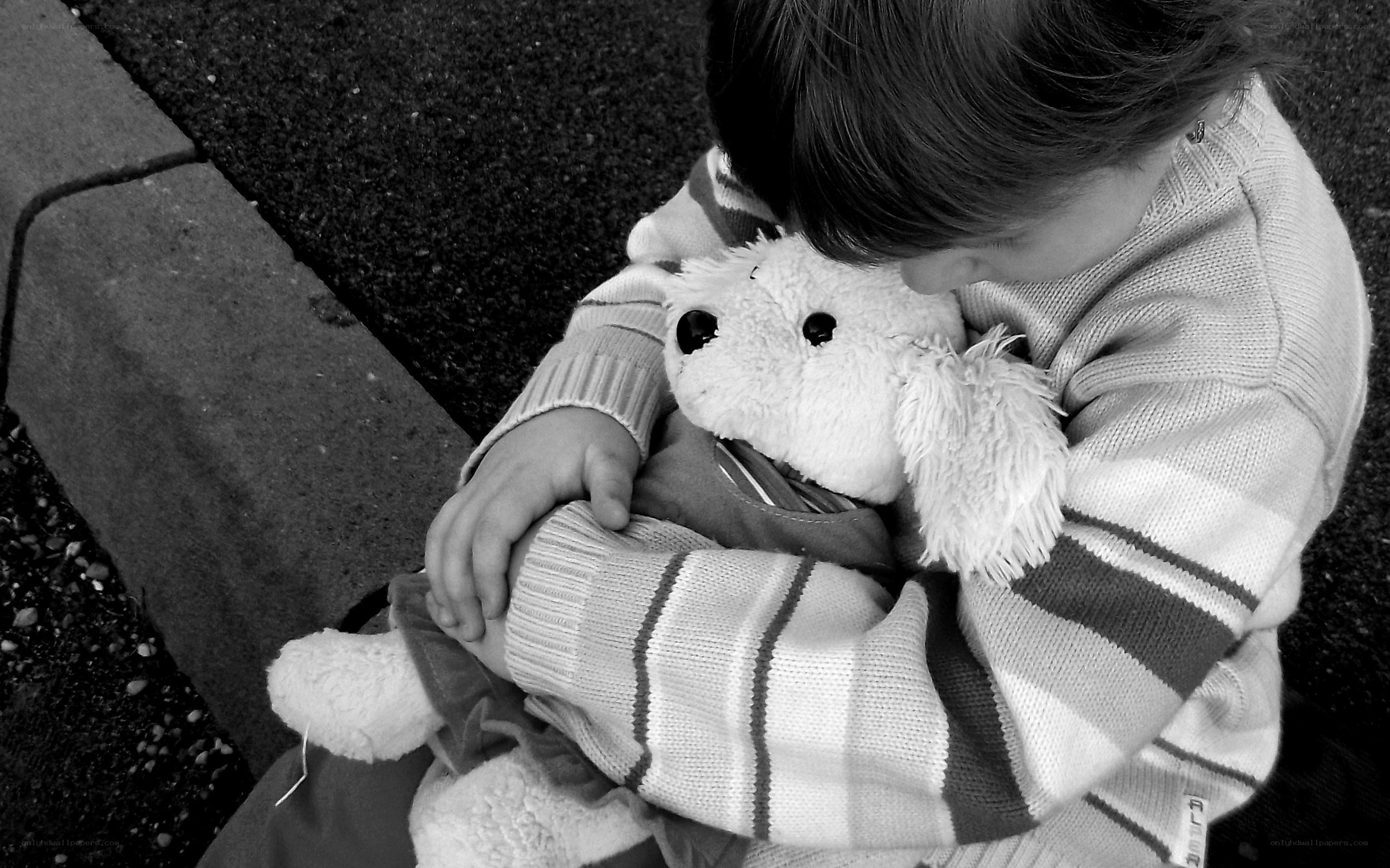 child hugging stuffed animal