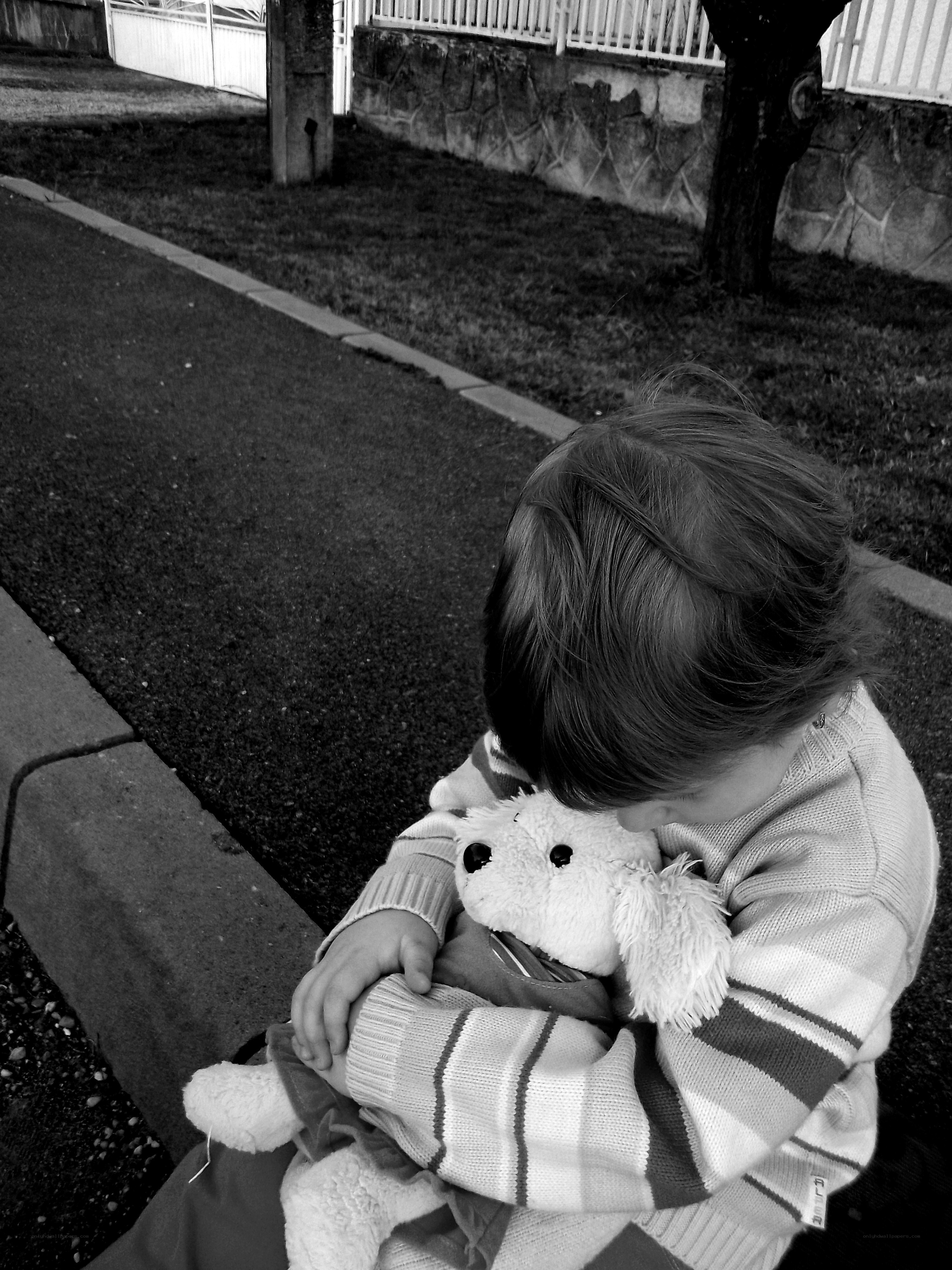 child hugging stuffed animal