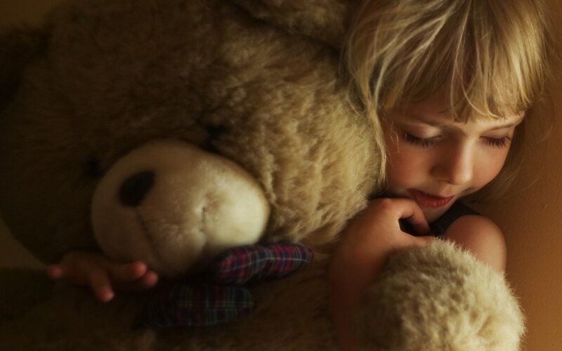 Child Hugging Teddy Bear — Brown