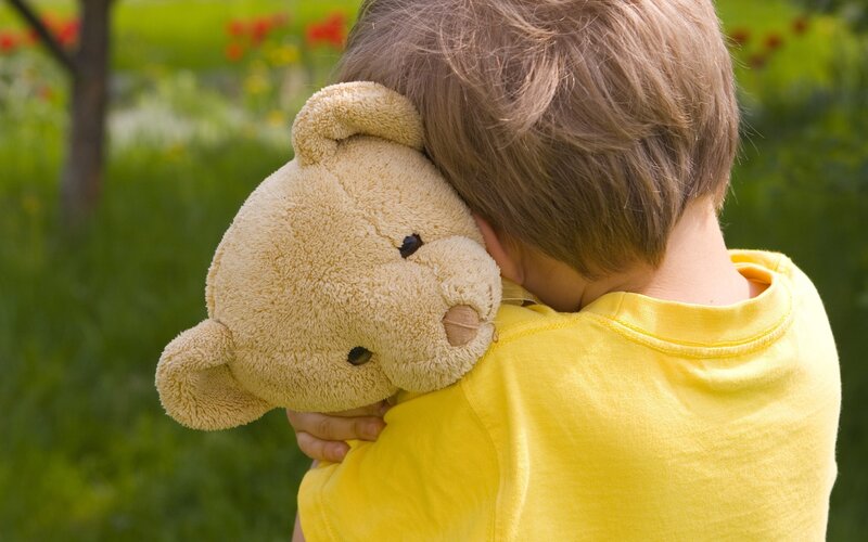 Child Hugging Teddy Bear — Yellow, Calm