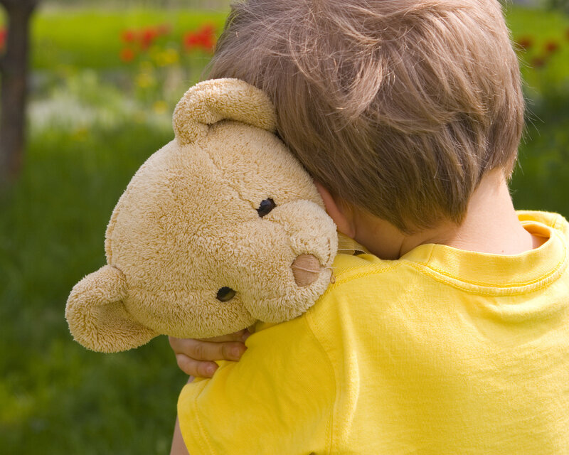 Child Hugging Teddy Bear — Yellow, Peaceful