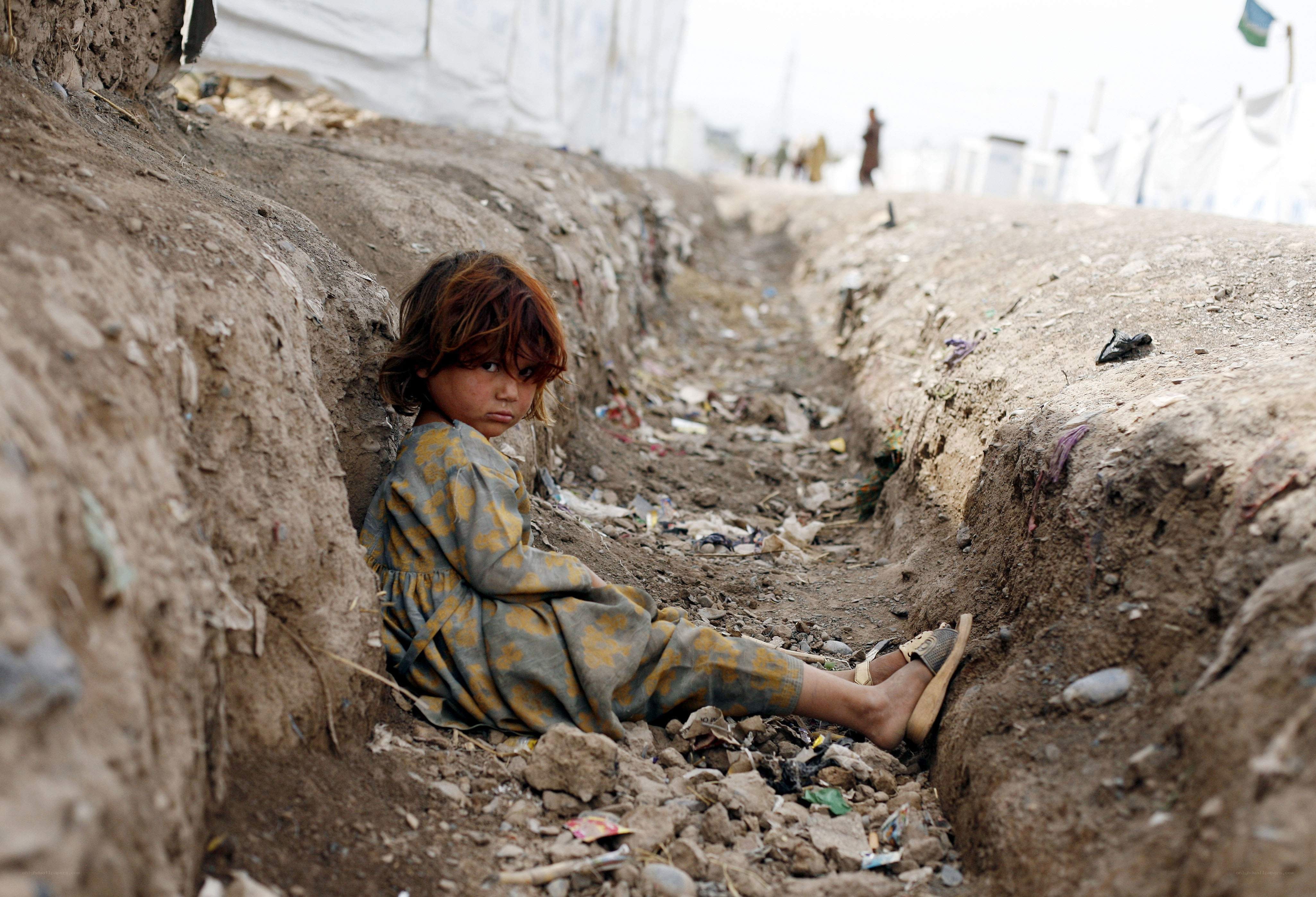 Child in a drainage ditch