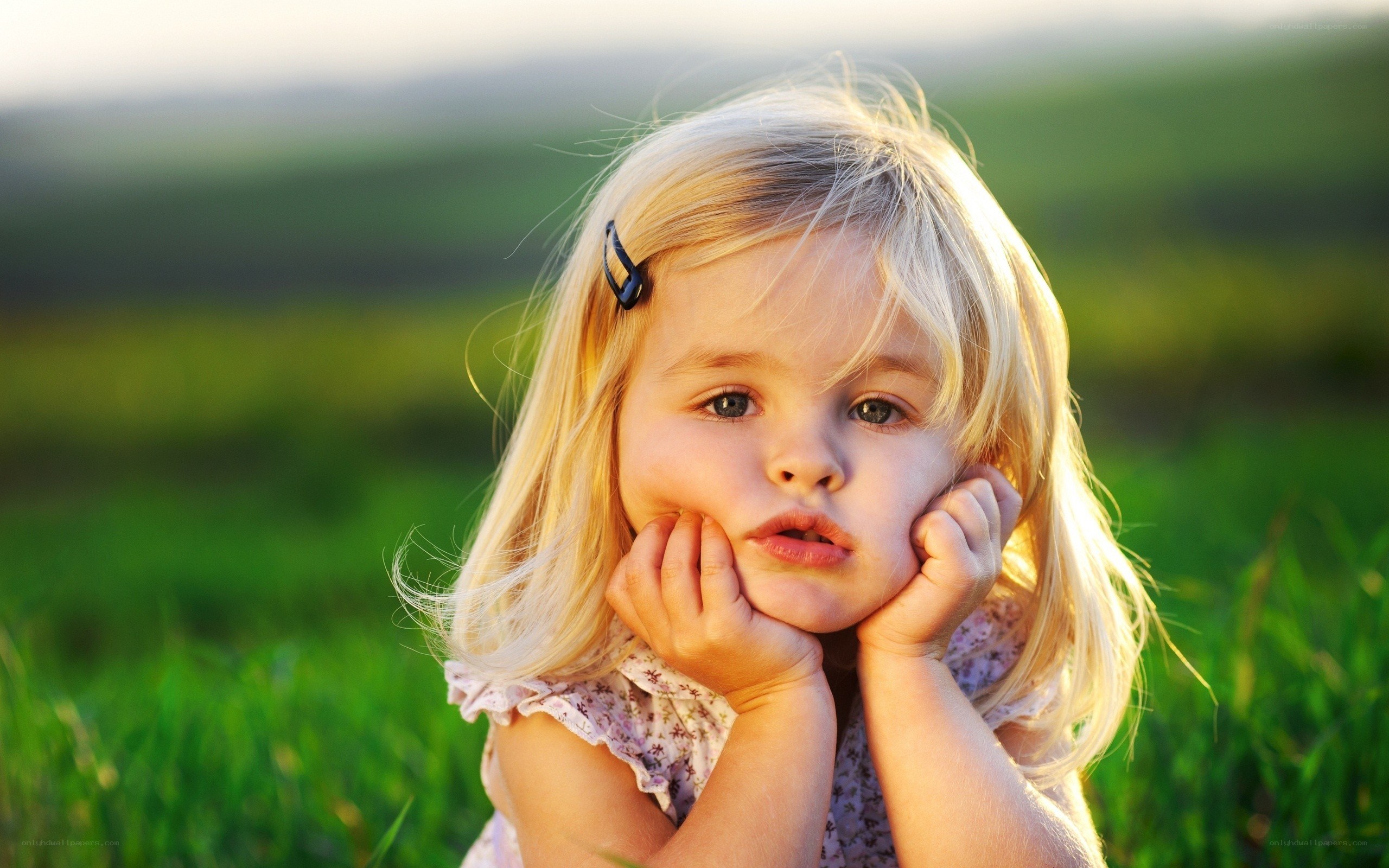 child in a green field