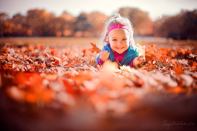 Child in Autumn Leaves — Orange