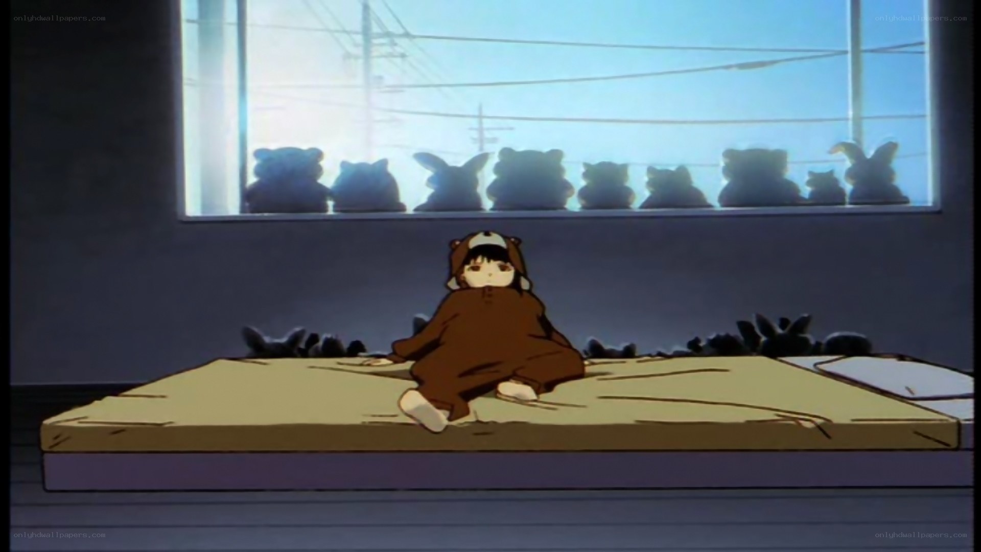 child in bear costume on bed