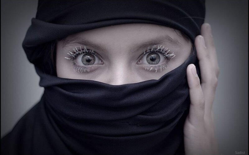 child in black headscarf