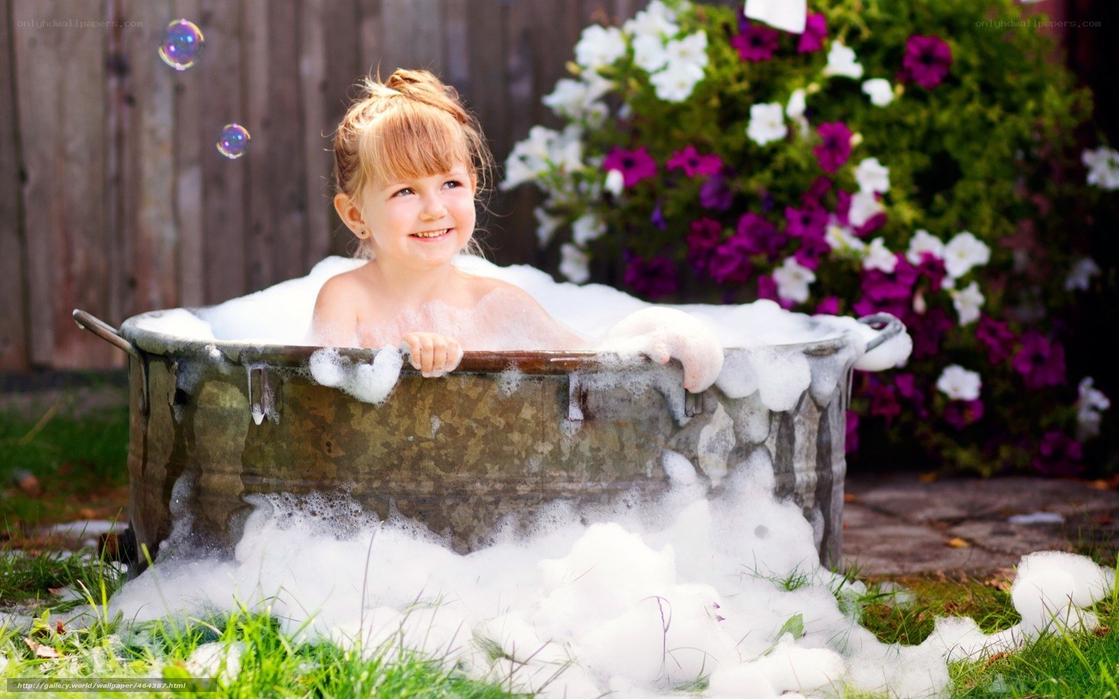 child in bubble bath outdoors