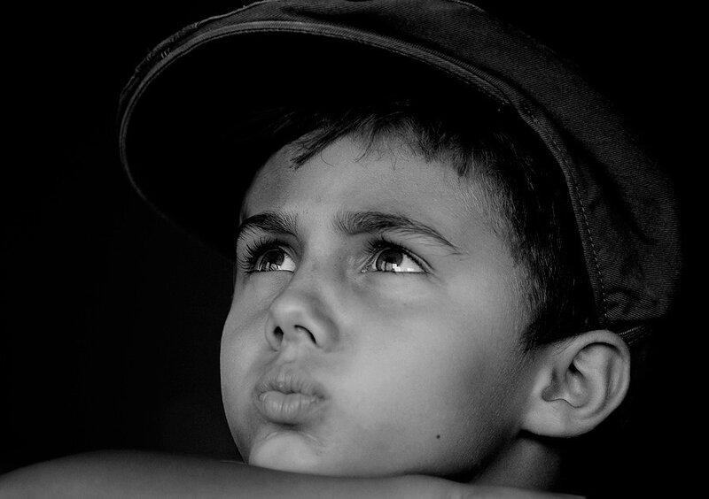 child in cap looking up
