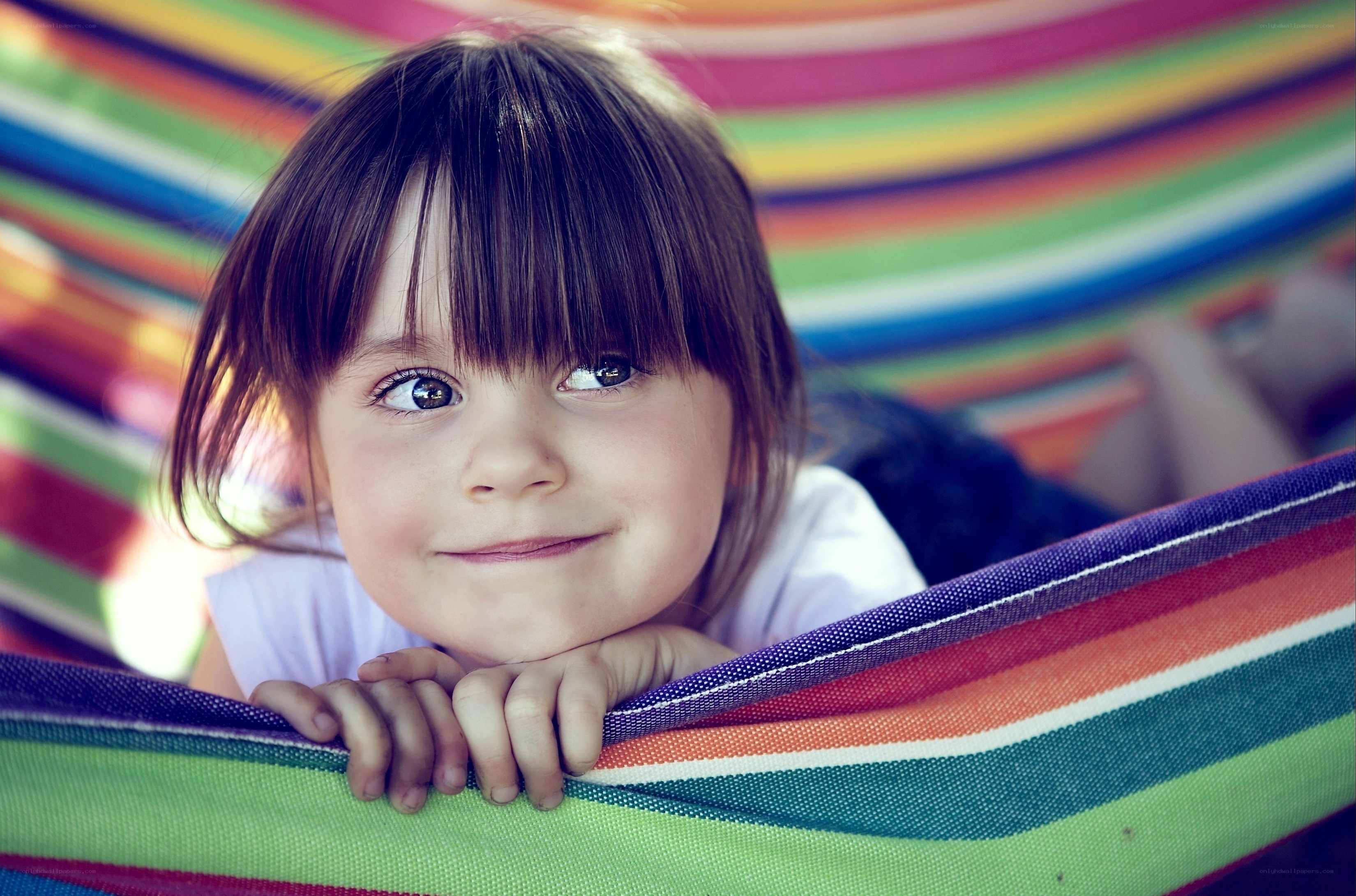 child in colorful hammock