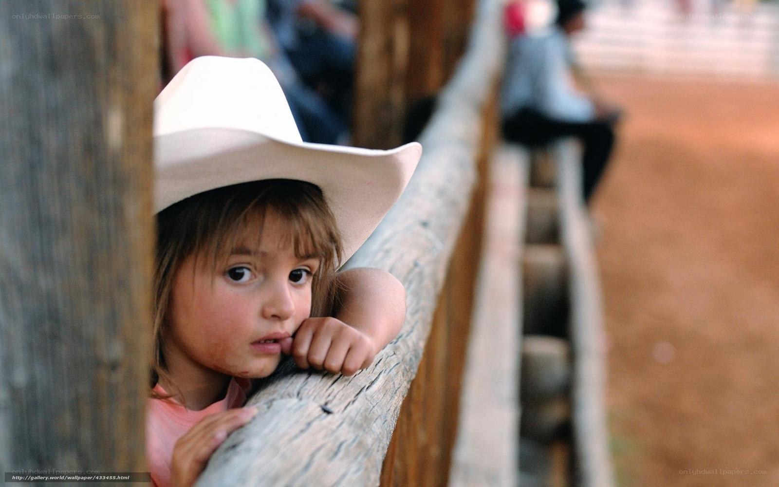 child in cowboy hat at rodeo