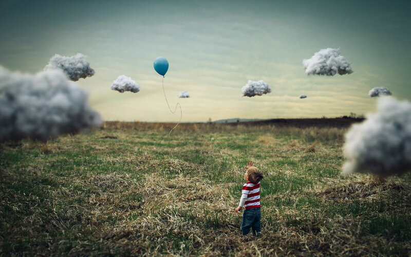 Child in Field with Balloon