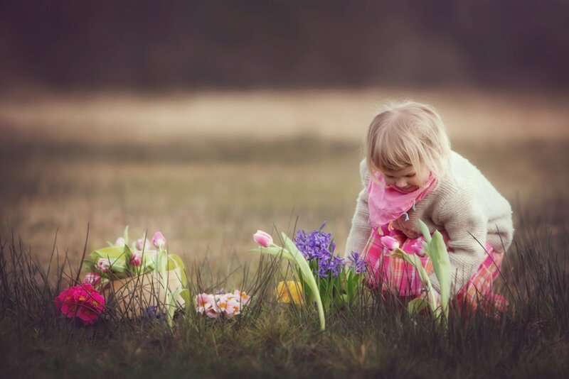 Child in Field with Flowers