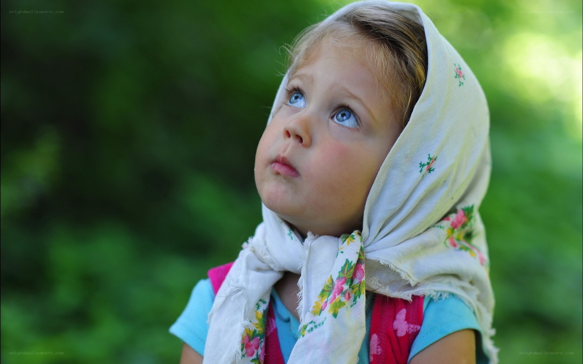 child in floral headscarf