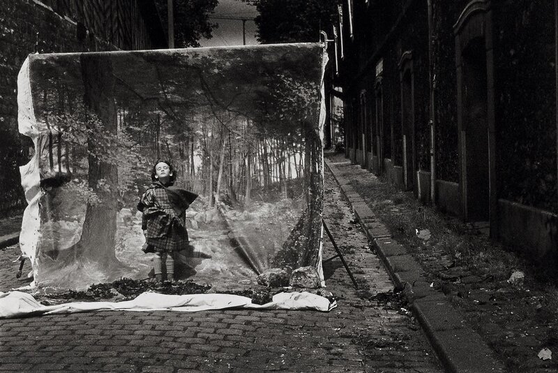 Child in forest backdrop on street