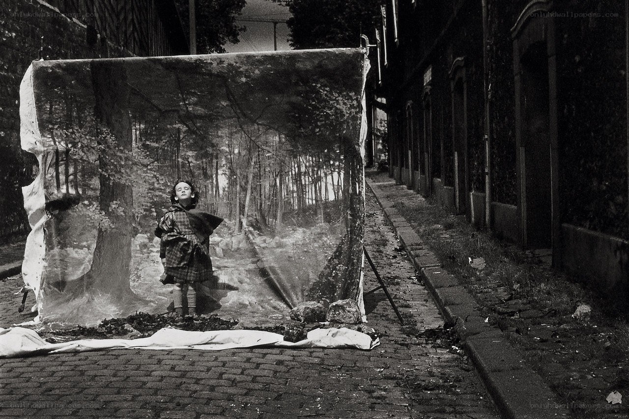 Child in forest backdrop on street