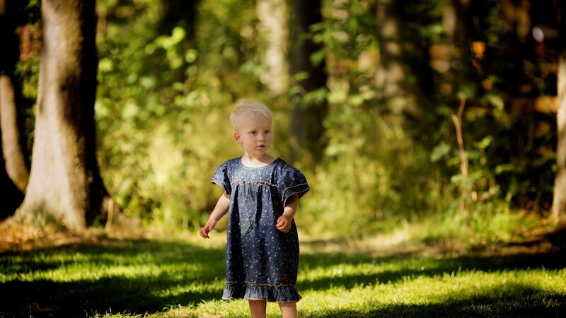 Child in forest sunlight