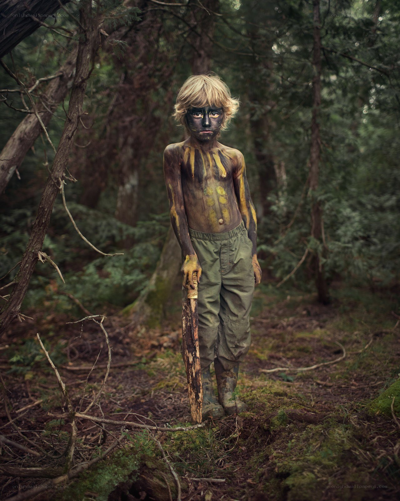 child in forest with face paint