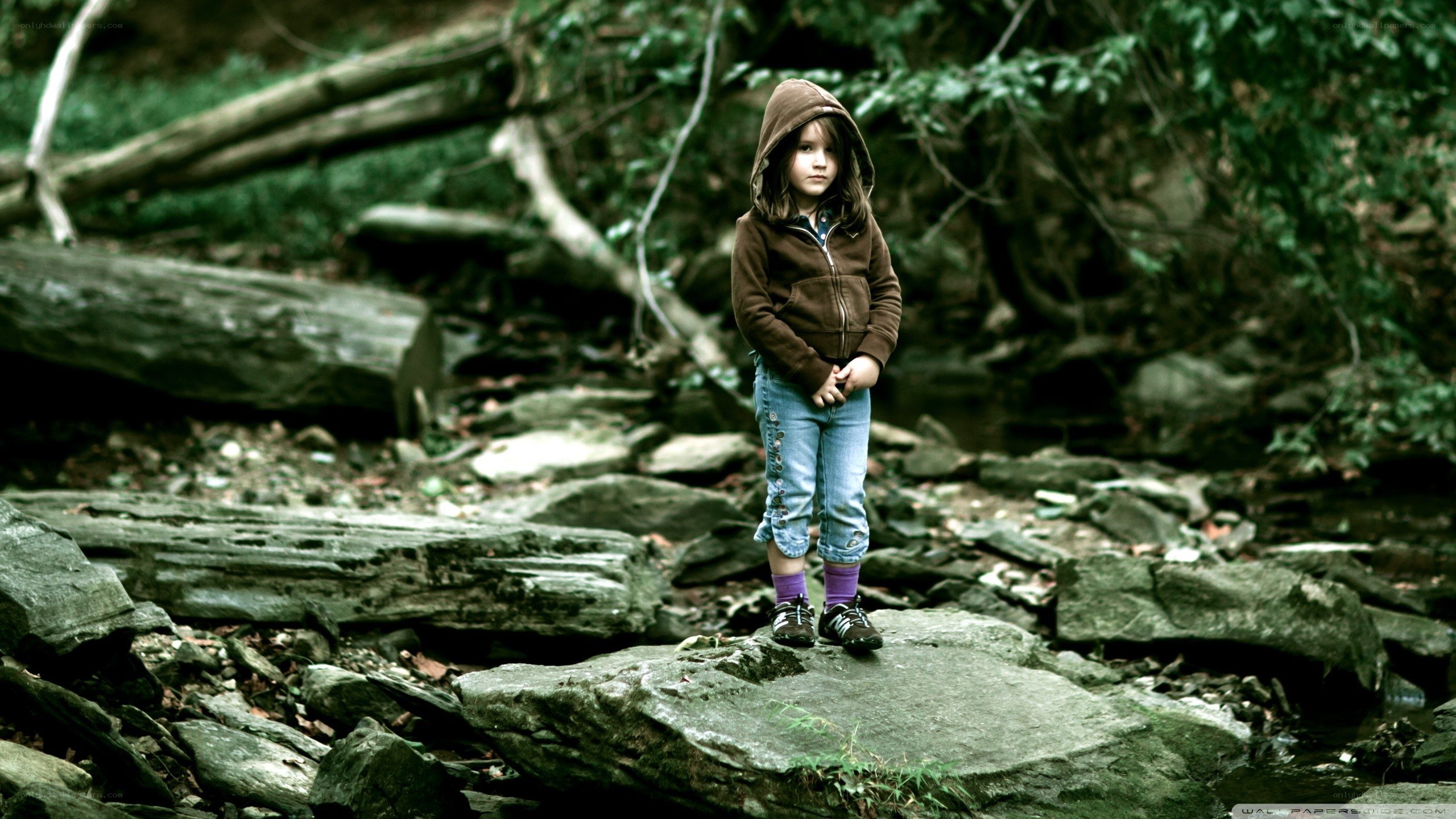 Child in forest with hooded jacket