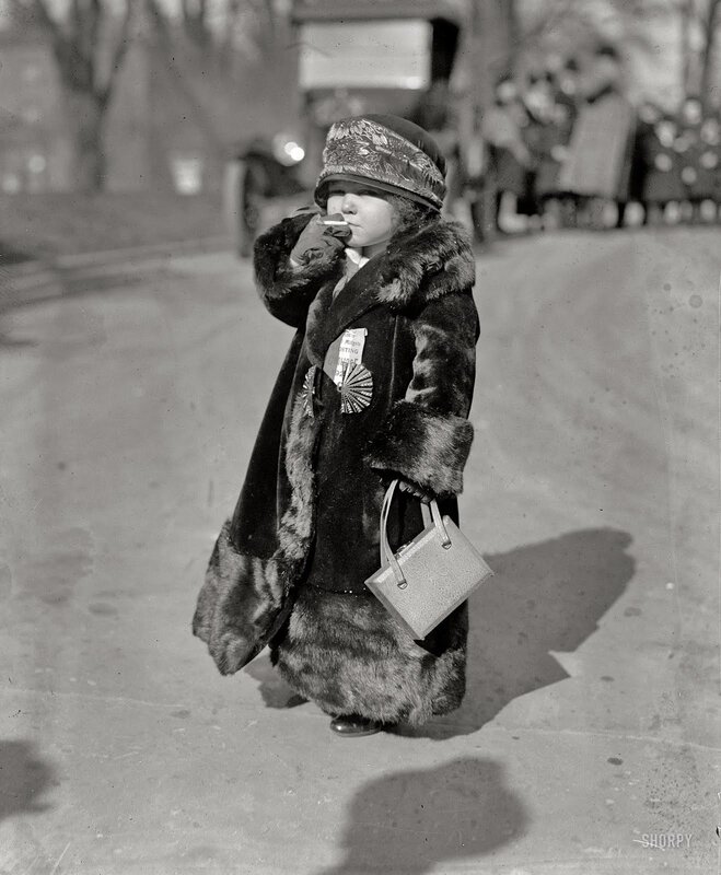 Child in fur coat with handbag