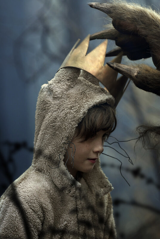 child in furry costume with crown