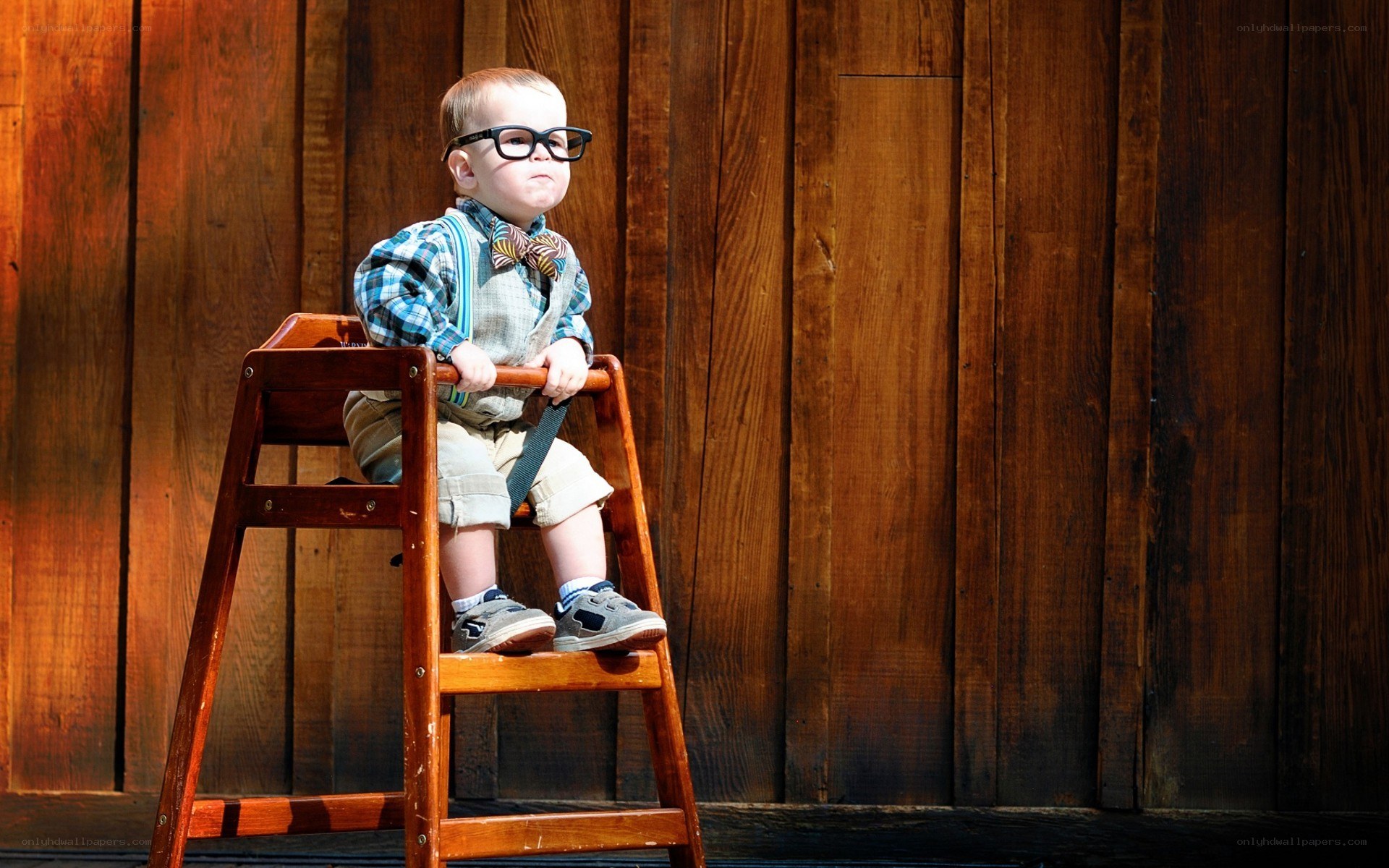child in glasses on a stool