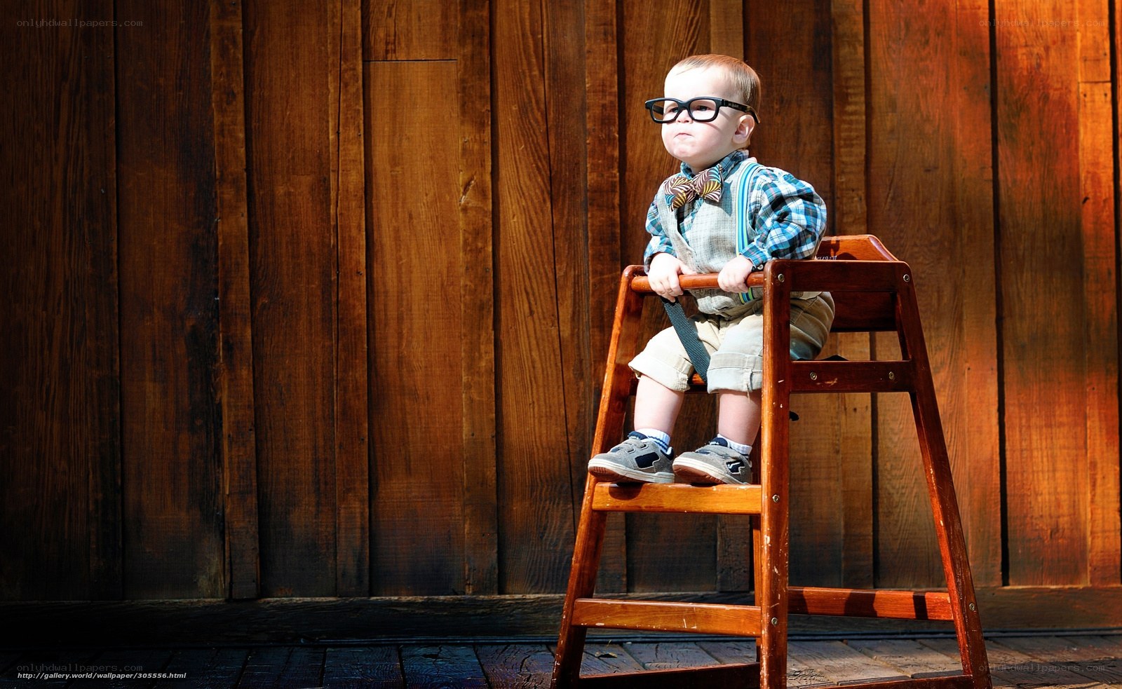 child in glasses on stool