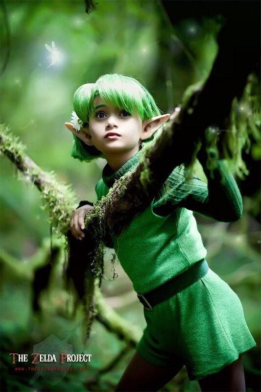 child in green elf costume
