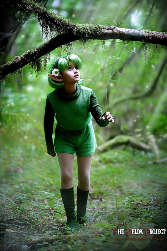 child in green elf costume