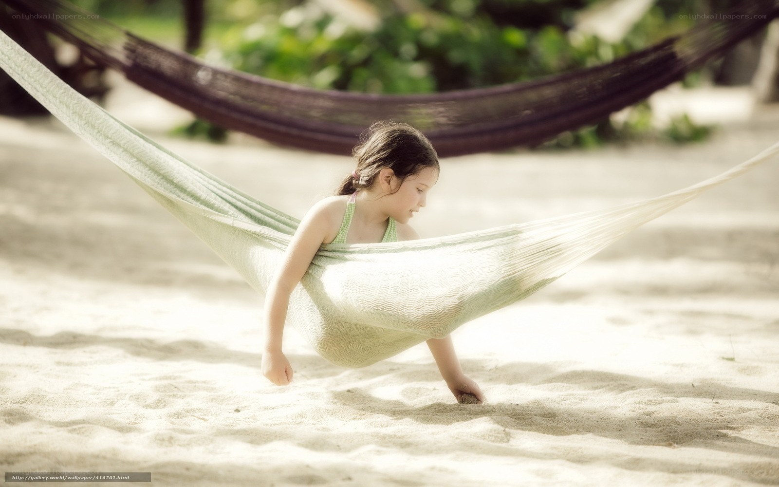 child in hammock on beach