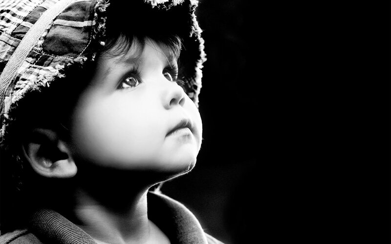 child in hat looking up