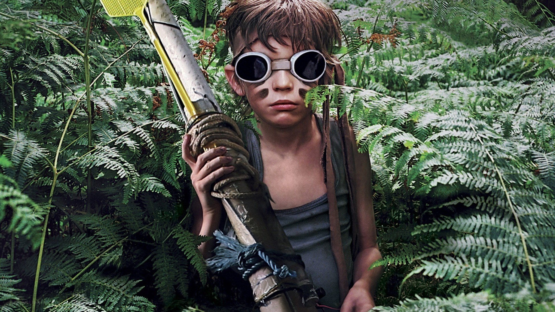 child in jungle with weapon