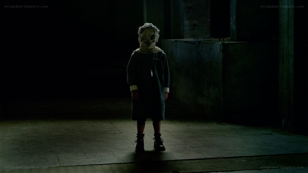 child in mask stands alone