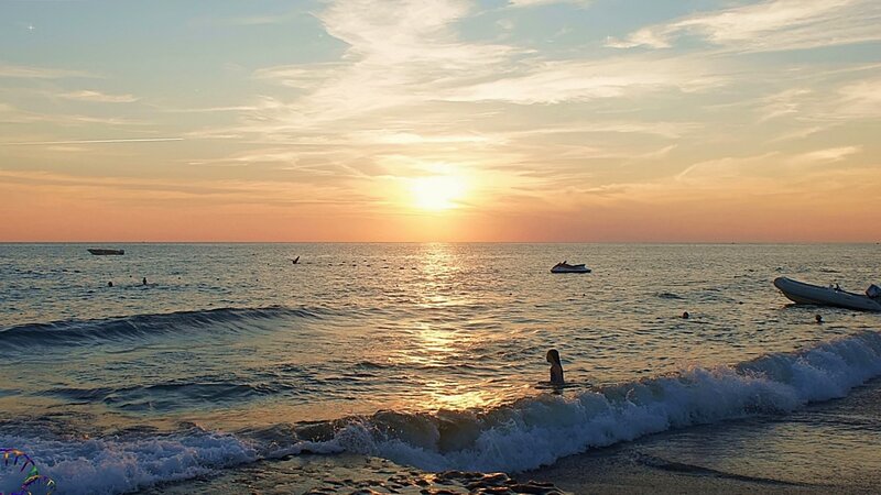 Child in Ocean at Sunset