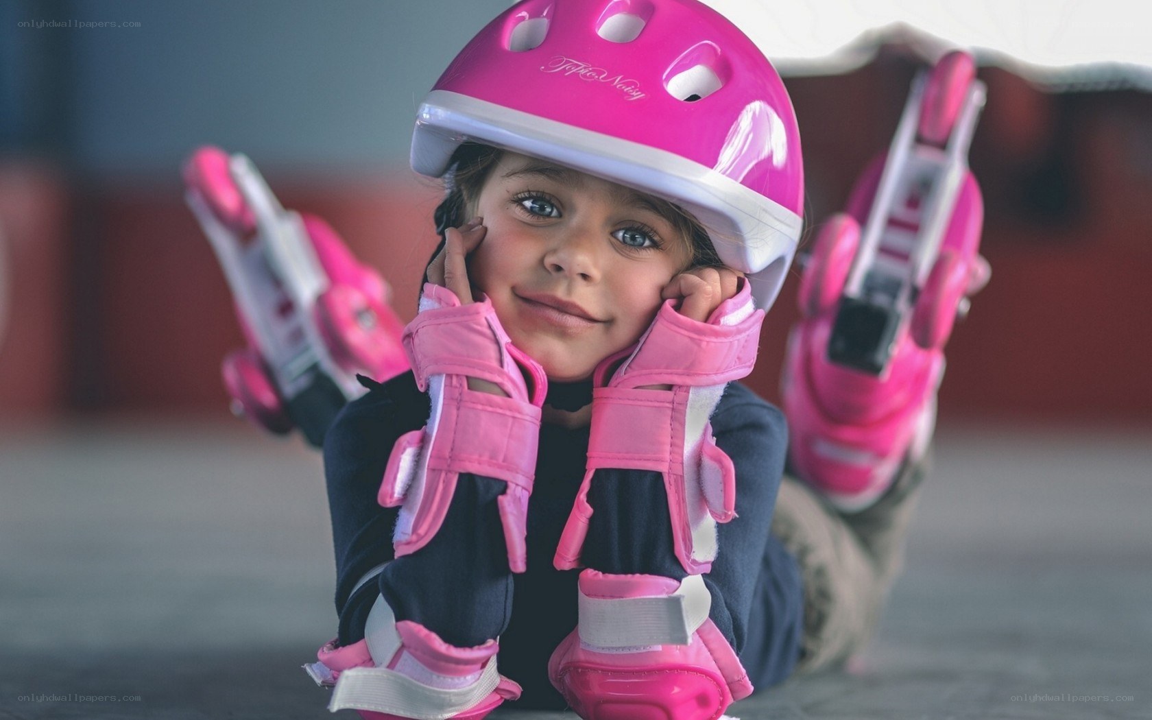 child in pink roller gear
