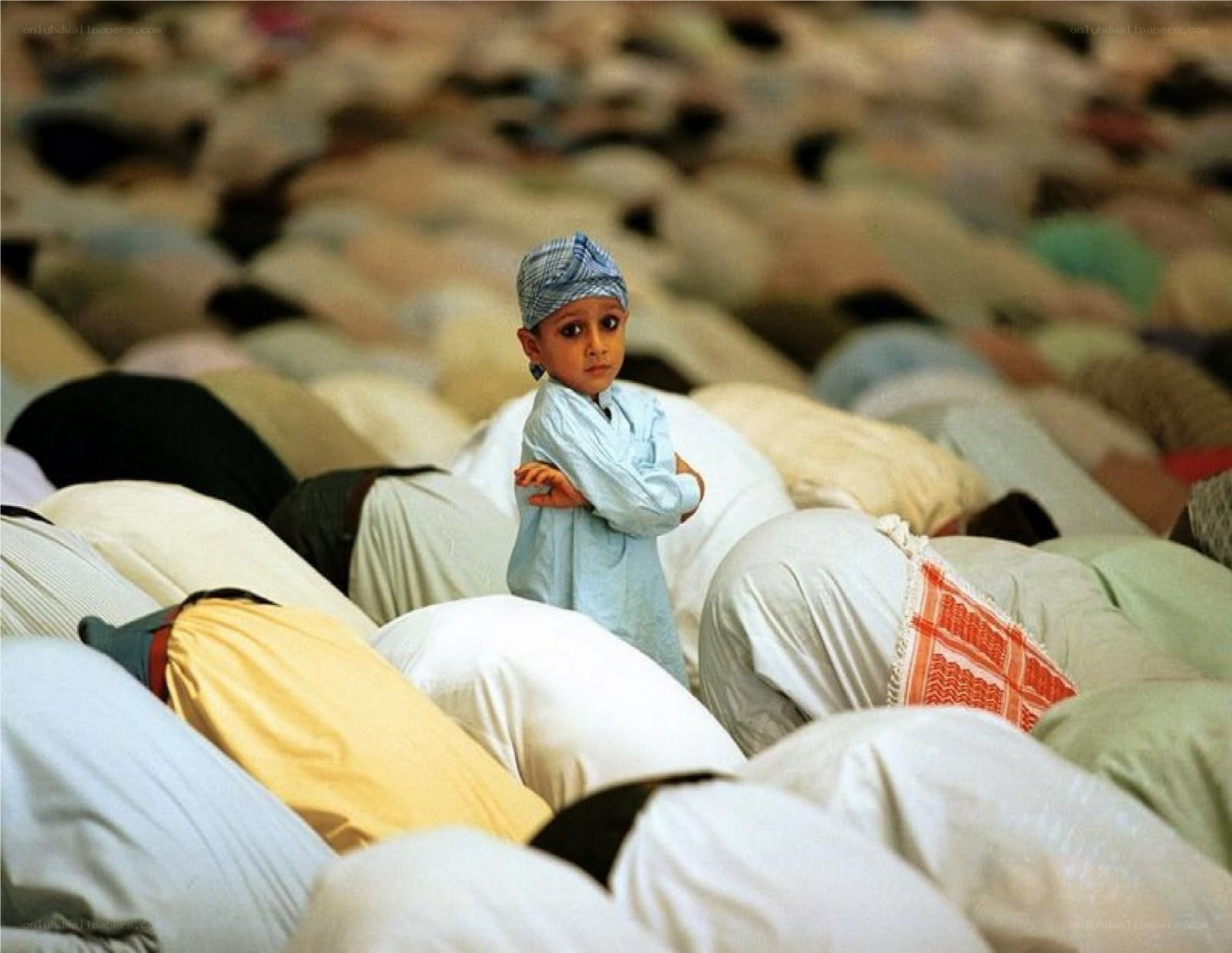 Child in prayer among worshippers
