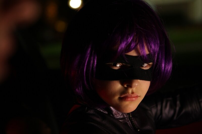 child in purple wig and mask