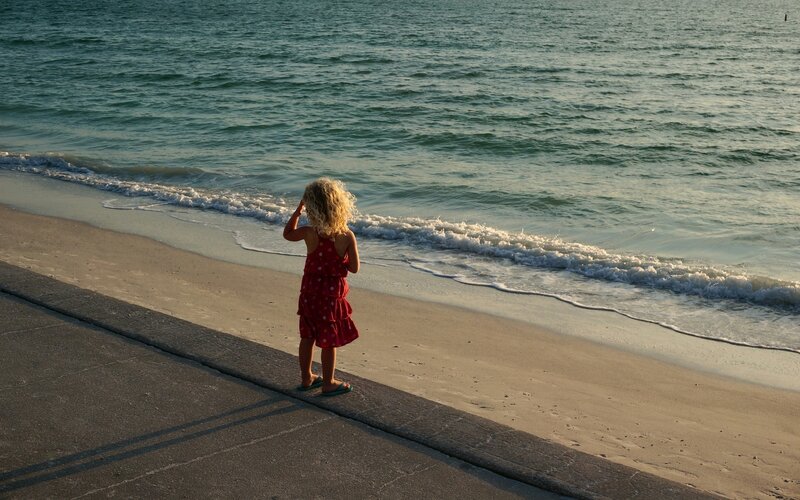 Child in Red Dress — Serene, Sunset, Photograph