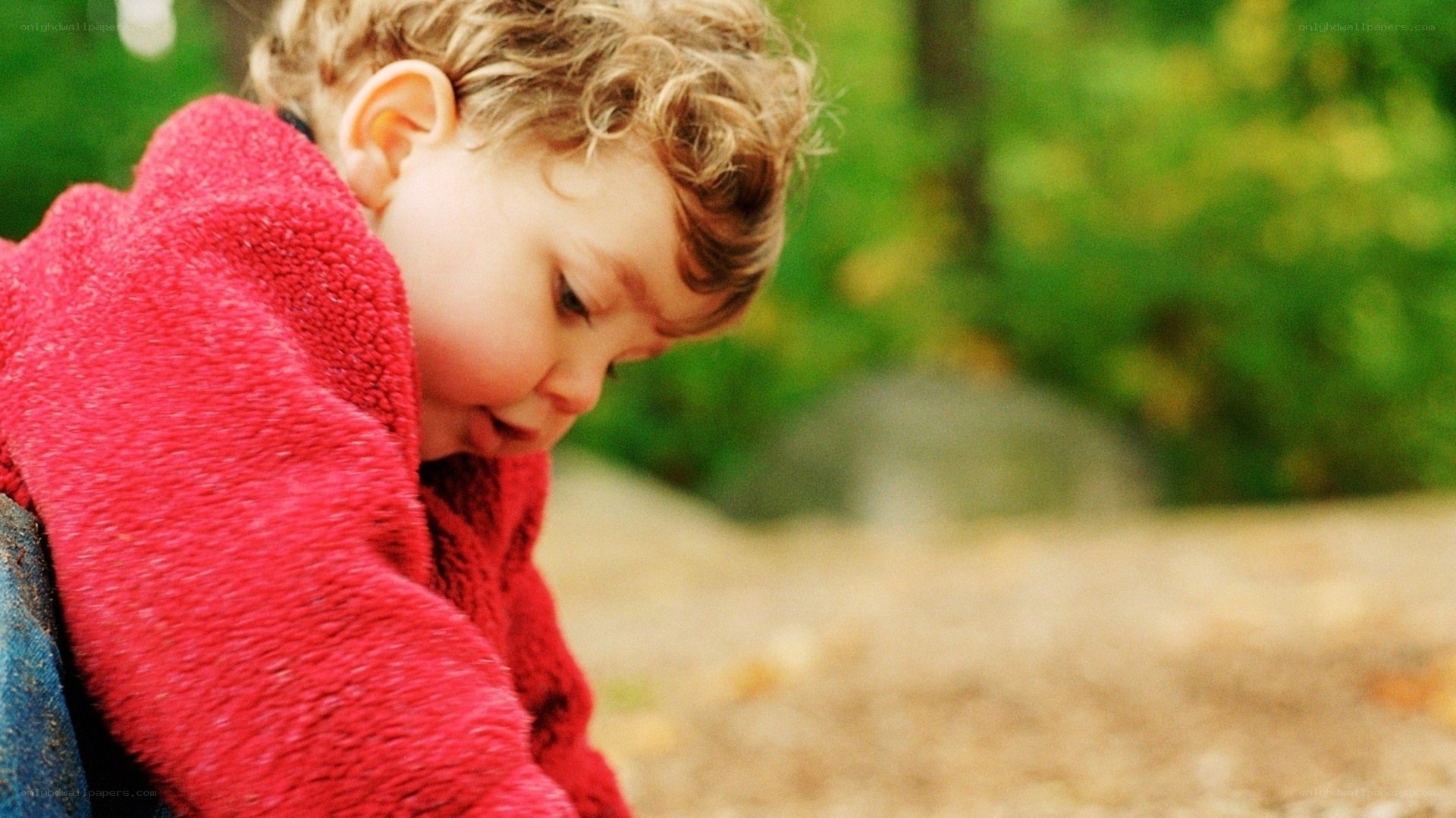 child in red jacket outdoors