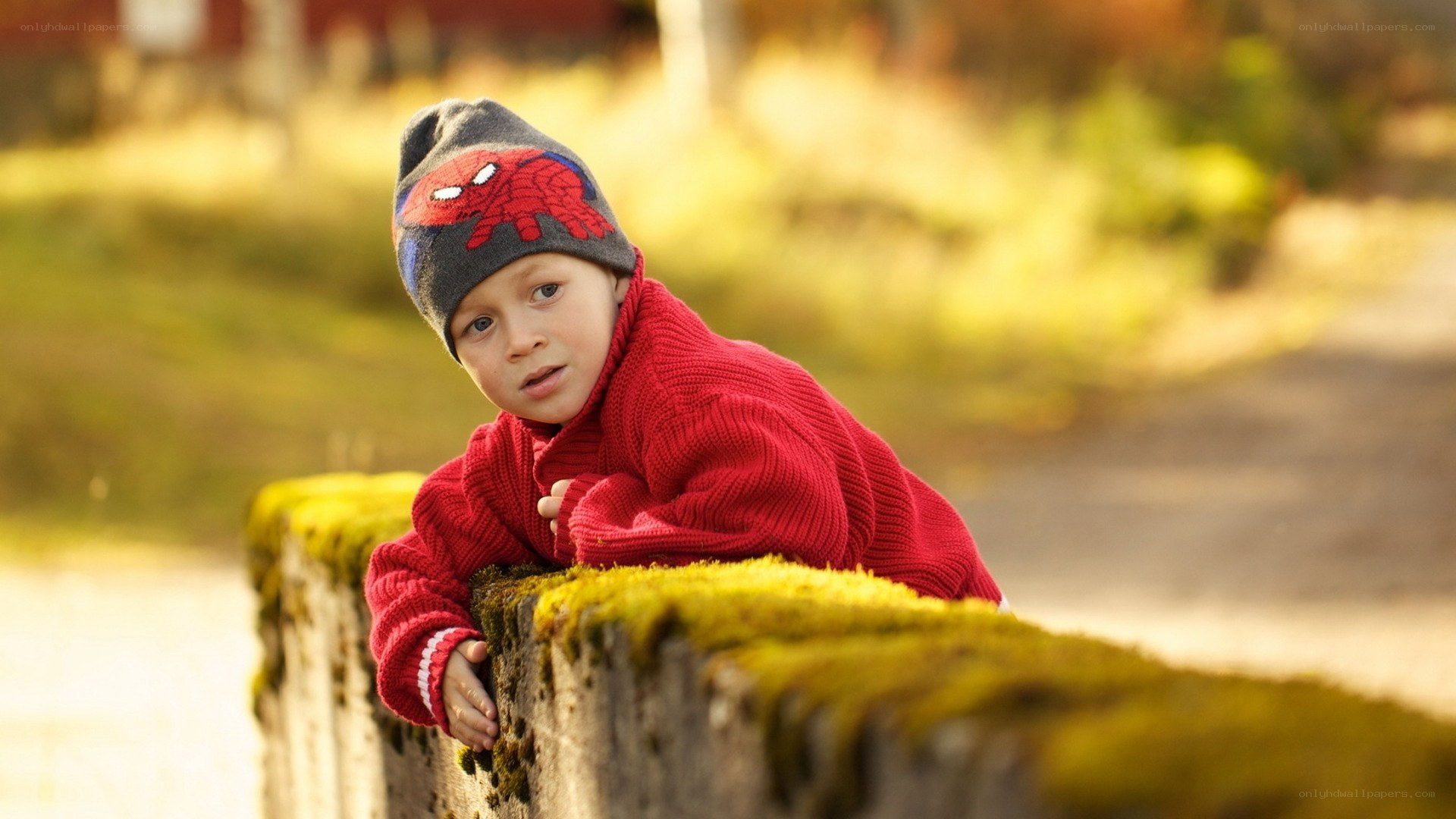 child in red sweater and hat