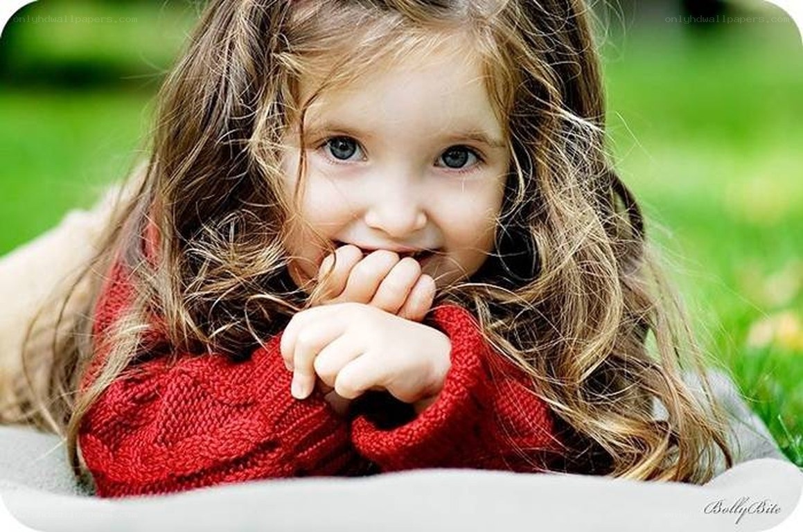 child in red sweater outdoors