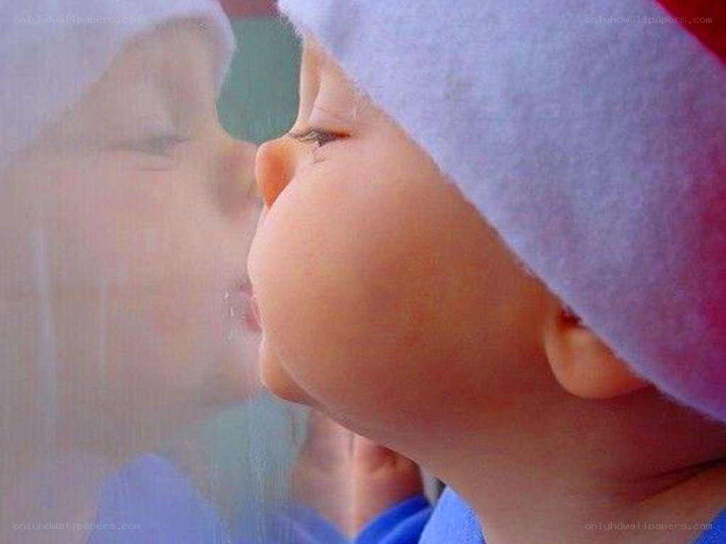 child in santa hat looking out window