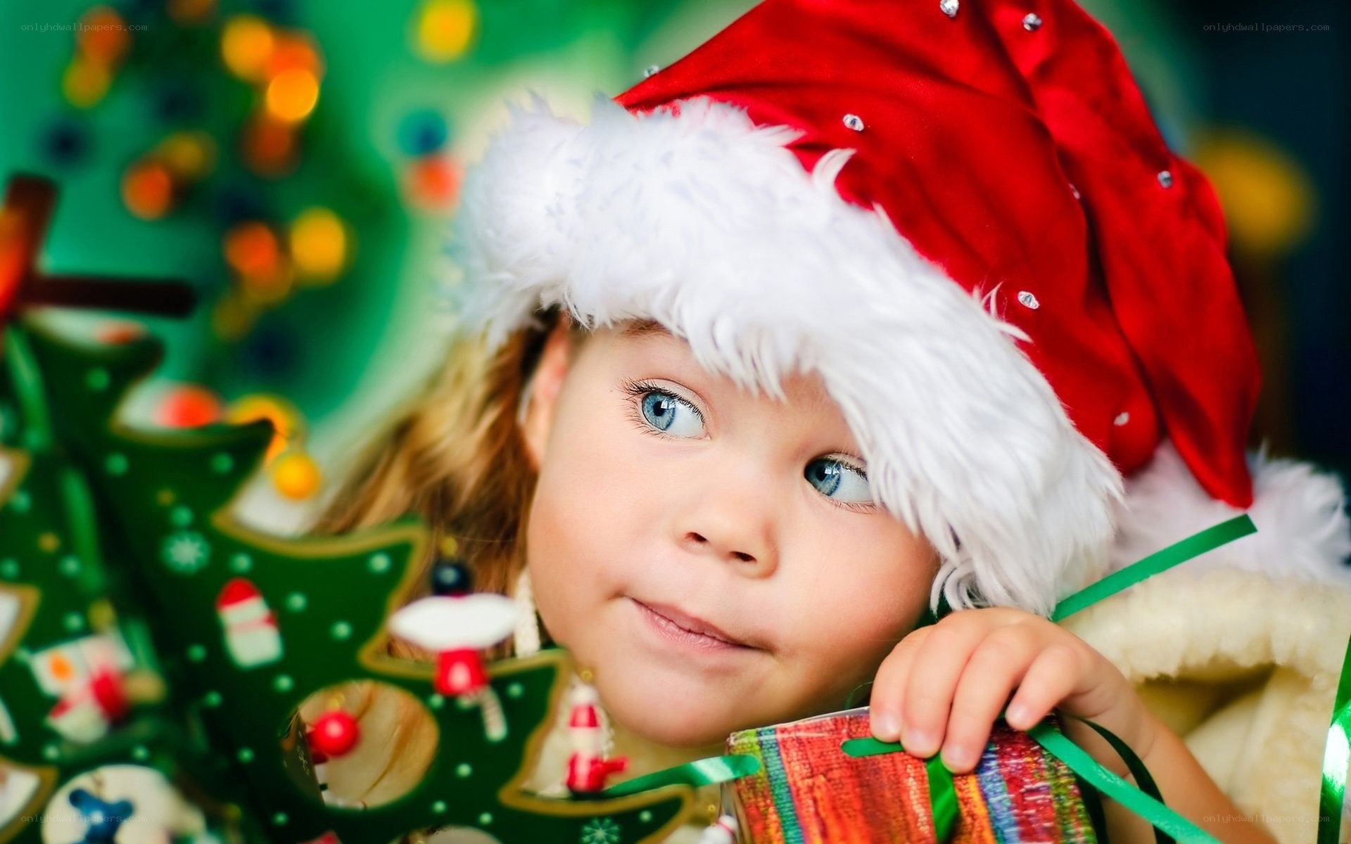 child in santa hat with gift