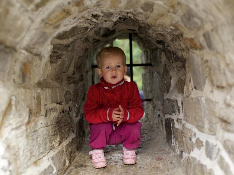 Child in Stone Tunnel — Red