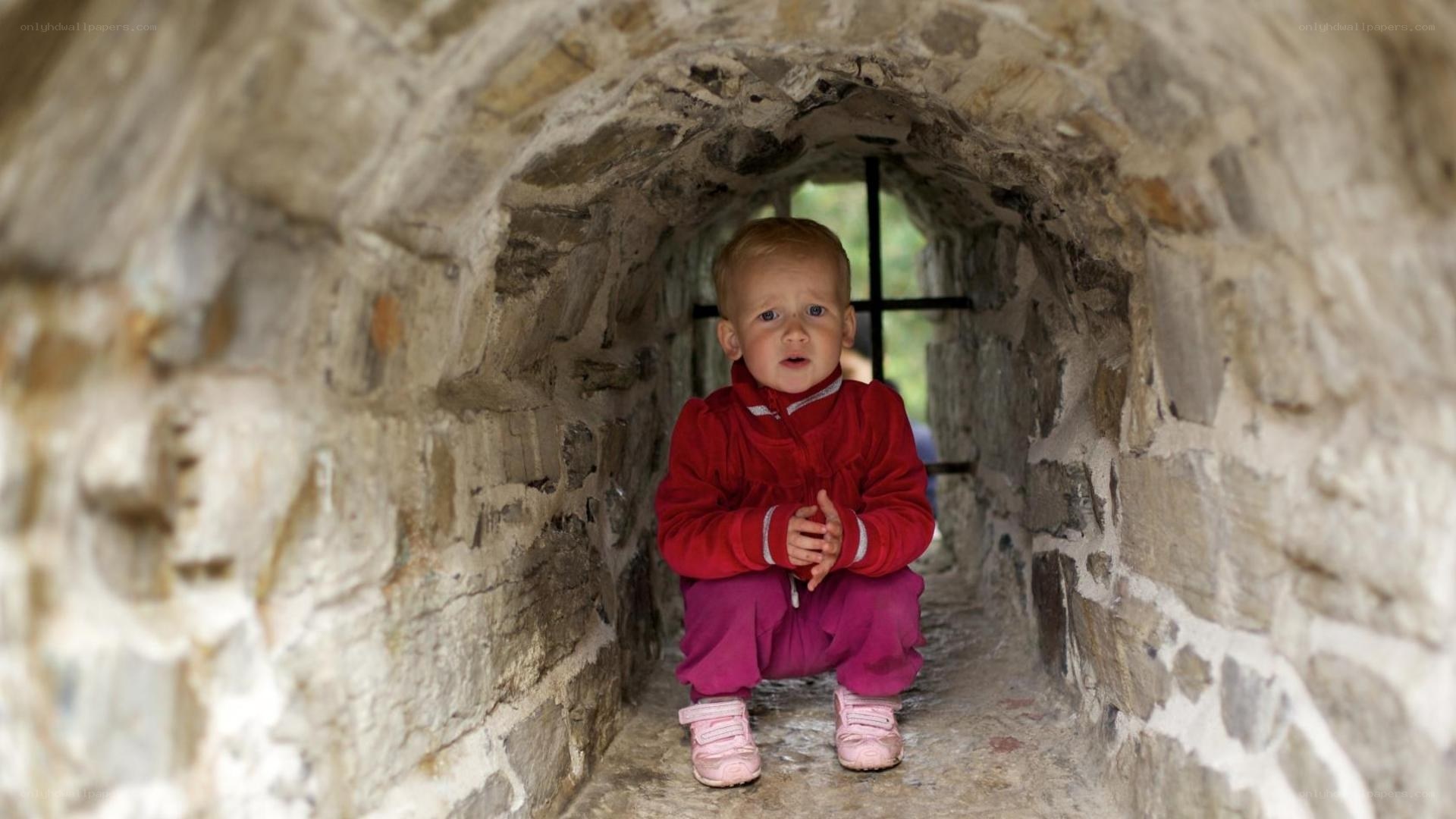 child in stone tunnel