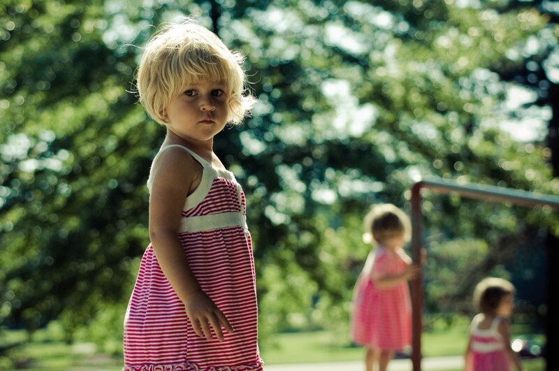 Child in striped dress at park